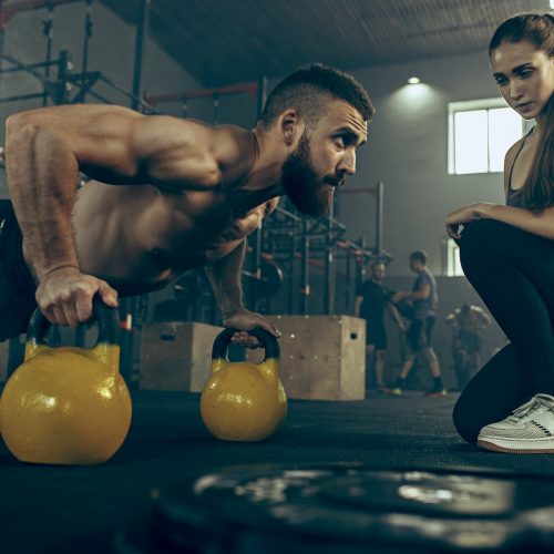 fit-young-man-lifting-barbells-working-out-in-a-gym.jpg